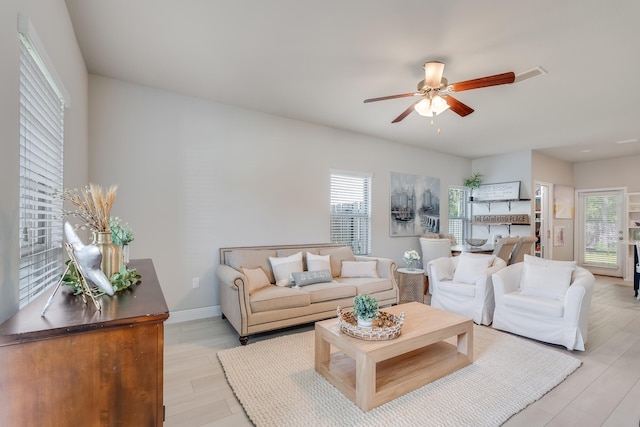 living room with ceiling fan and light hardwood / wood-style flooring