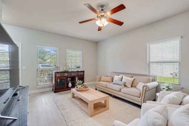 living room with ceiling fan and light wood-type flooring