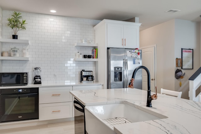 168 Secret St, Freeport, FL 32439 - kitchen featuring black appliances, open shelves, a sink, tasteful backsplash, and white cabinets