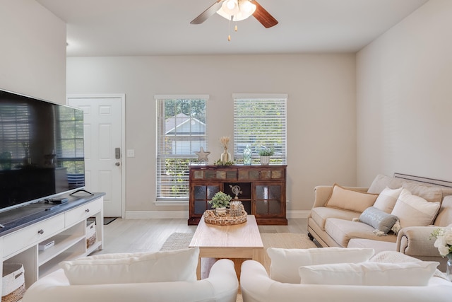 living room featuring light hardwood / wood-style floors and ceiling fan