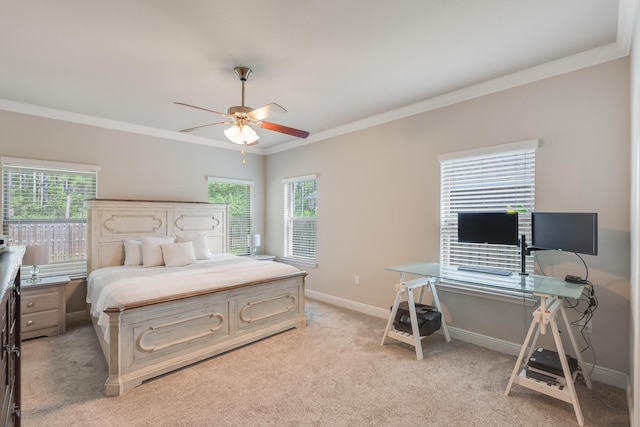 bedroom with ceiling fan, crown molding, light carpet, and multiple windows