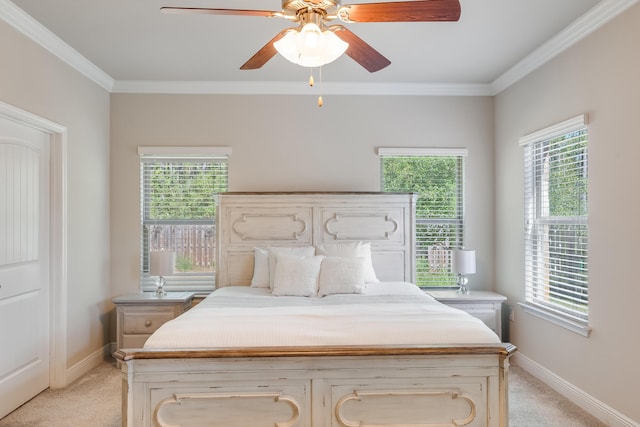 carpeted bedroom featuring multiple windows, ceiling fan, and ornamental molding