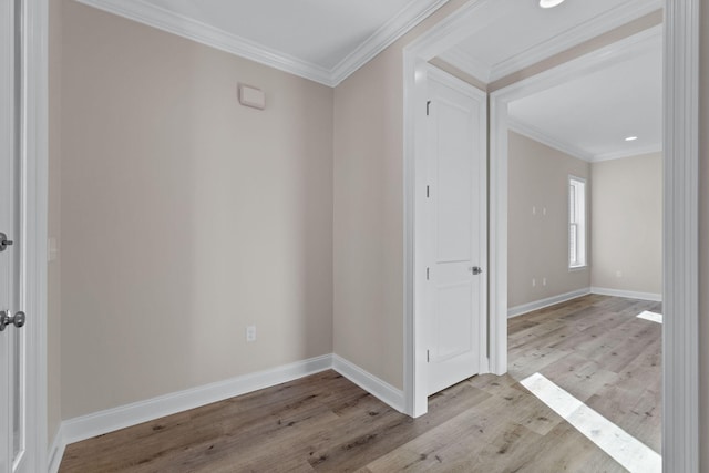 empty room with light wood-type flooring and ornamental molding