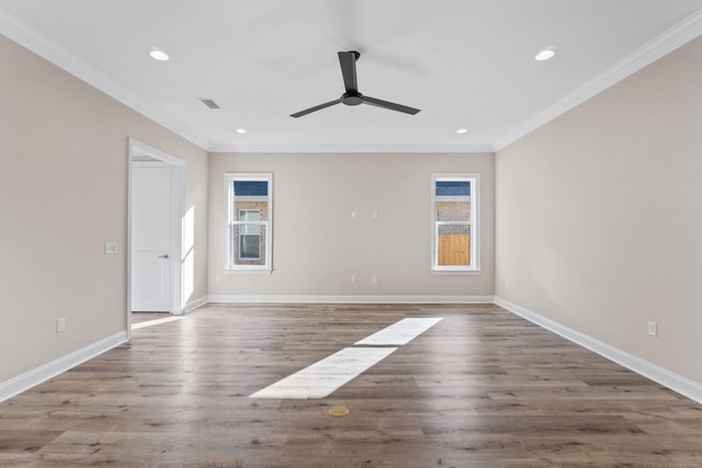 empty room featuring hardwood / wood-style flooring, ceiling fan, and ornamental molding