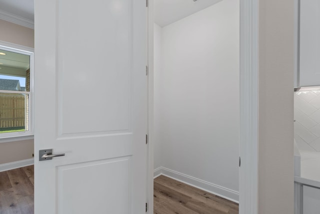 interior space featuring hardwood / wood-style flooring and crown molding