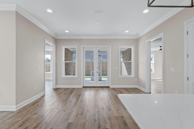 unfurnished living room featuring french doors, light wood-type flooring, ceiling fan, and ornamental molding