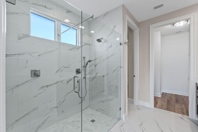 bathroom with vanity and a shower with door