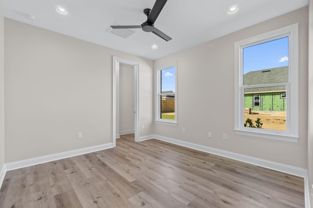 spare room with ceiling fan and light hardwood / wood-style floors