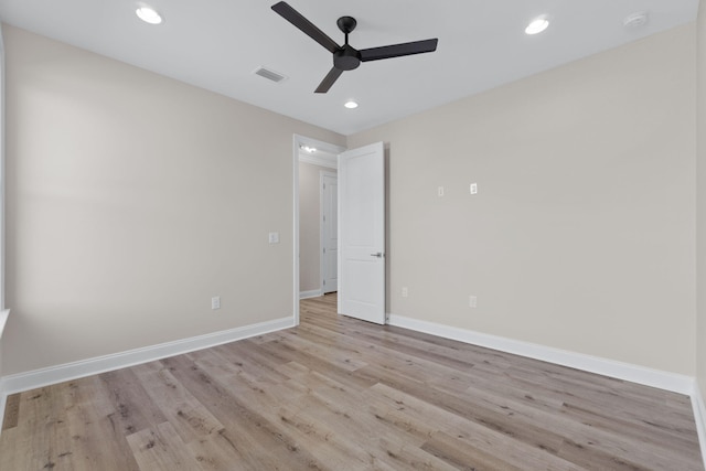 empty room with ceiling fan and light hardwood / wood-style flooring