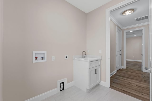 washroom featuring electric dryer hookup, crown molding, sink, hookup for a washing machine, and light tile patterned flooring