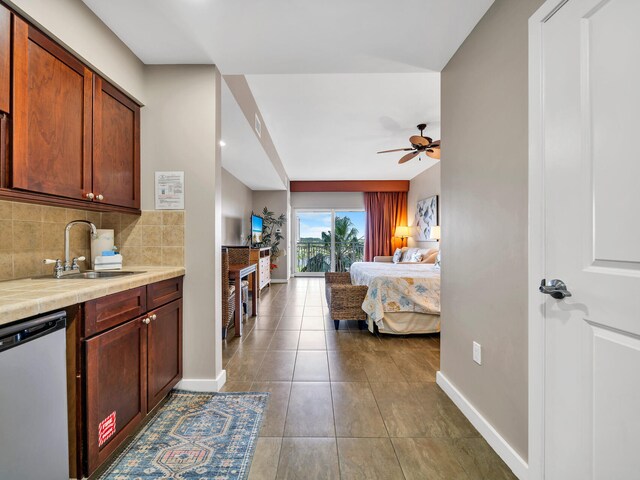 bedroom featuring sink, access to outside, ceiling fan, and dark tile patterned flooring