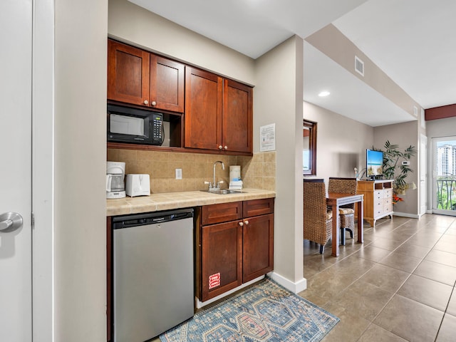 kitchen with sink, backsplash, light tile patterned floors, and dishwasher