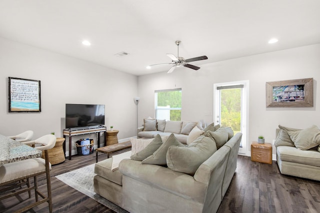 living room with dark wood-type flooring and ceiling fan