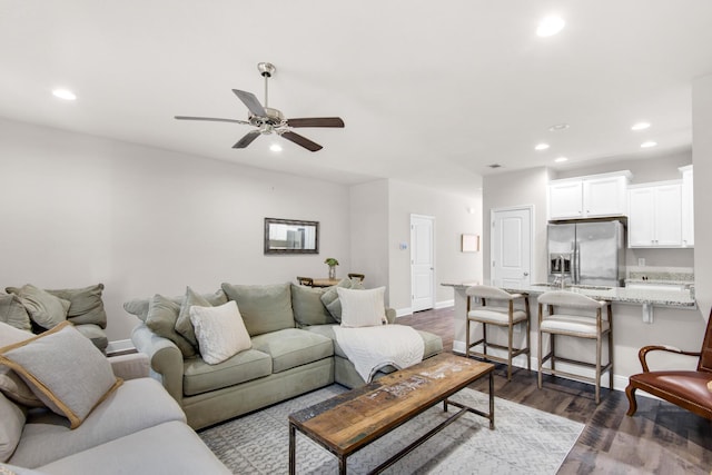 living room featuring dark hardwood / wood-style floors and ceiling fan