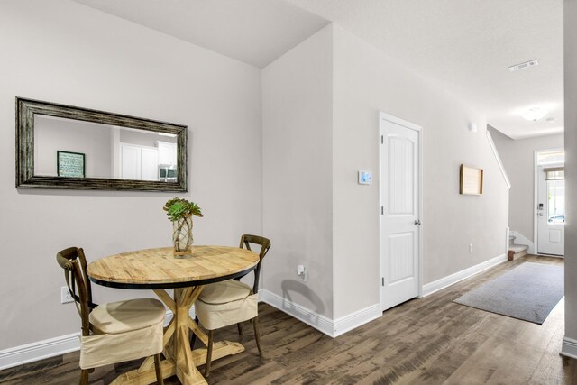 dining room with dark hardwood / wood-style flooring