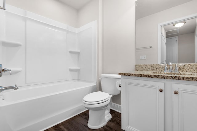 full bathroom featuring wood-type flooring, bathing tub / shower combination, vanity, and toilet