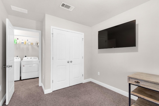 unfurnished bedroom with a closet, washing machine and clothes dryer, and carpet