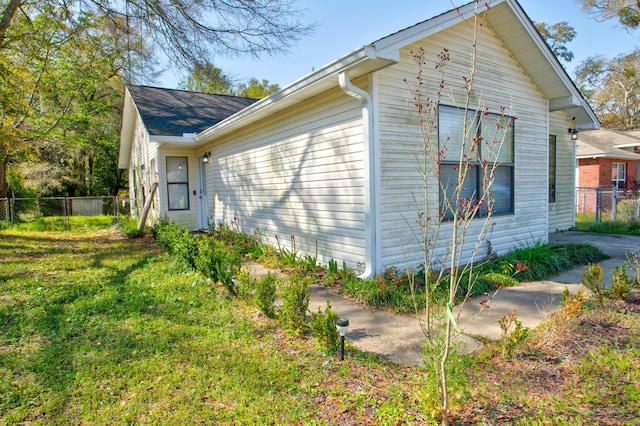 view of property exterior with a lawn