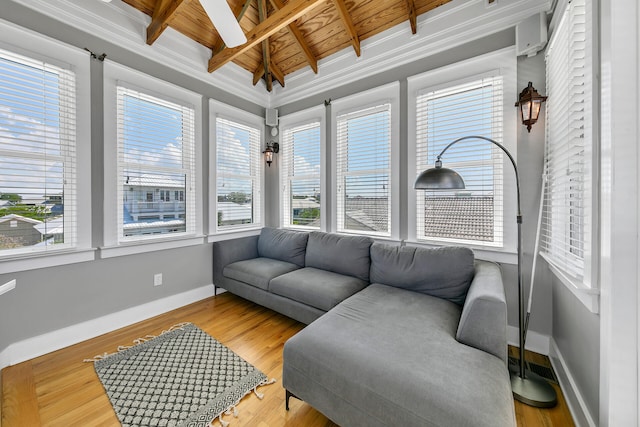 sunroom / solarium with vaulted ceiling with beams, a wealth of natural light, and wooden ceiling