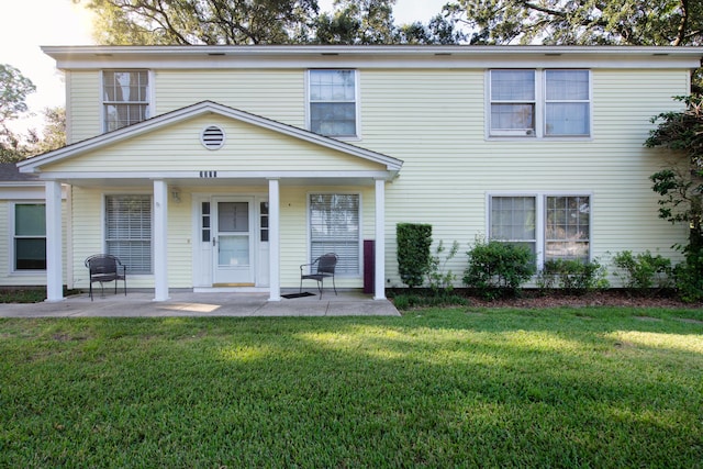 view of front of home with a patio and a front lawn