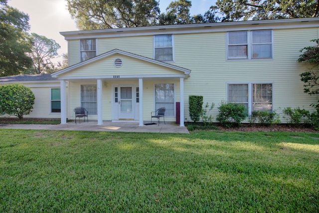 view of front of house with a front yard and a patio