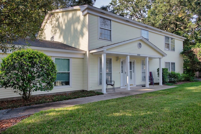 view of front of house with a porch and a front yard