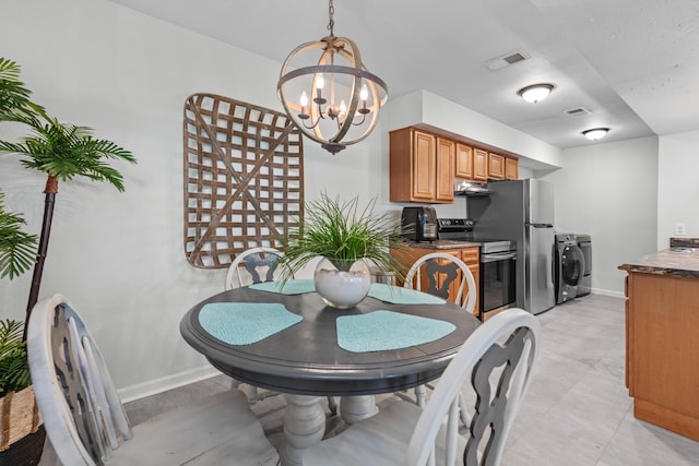 dining room with a notable chandelier and washer / dryer