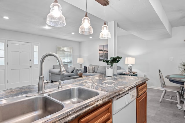 kitchen with pendant lighting, white dishwasher, and sink