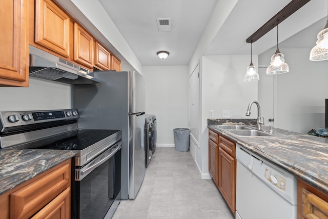 kitchen with stainless steel range with electric stovetop, white dishwasher, sink, exhaust hood, and separate washer and dryer