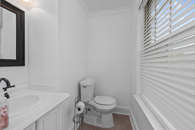 bathroom featuring toilet, vanity, and ornamental molding