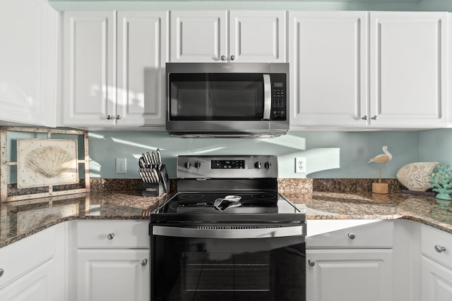 kitchen with white cabinets and appliances with stainless steel finishes