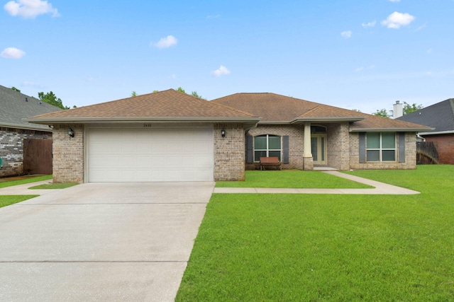 view of front of property featuring a garage and a front yard