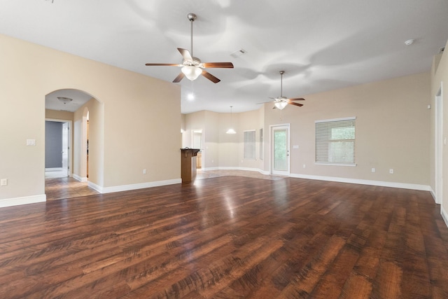 unfurnished living room with ceiling fan and dark hardwood / wood-style flooring