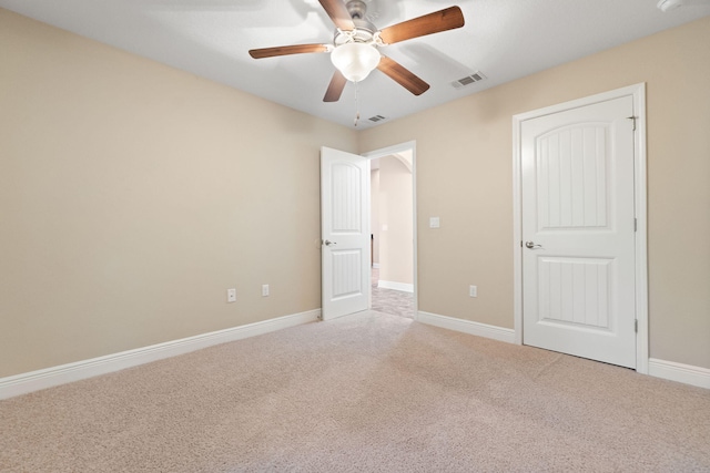 unfurnished bedroom with ceiling fan and carpet