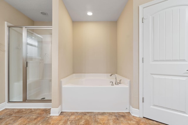 bathroom featuring independent shower and bath