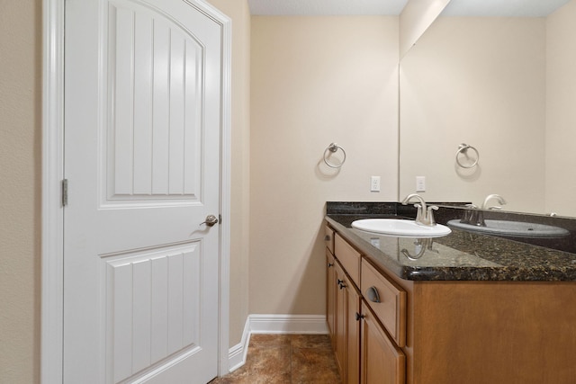 bathroom featuring tile patterned flooring and vanity