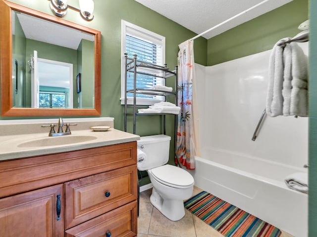 full bathroom featuring vanity, tile patterned floors, toilet, a textured ceiling, and shower / tub combo with curtain