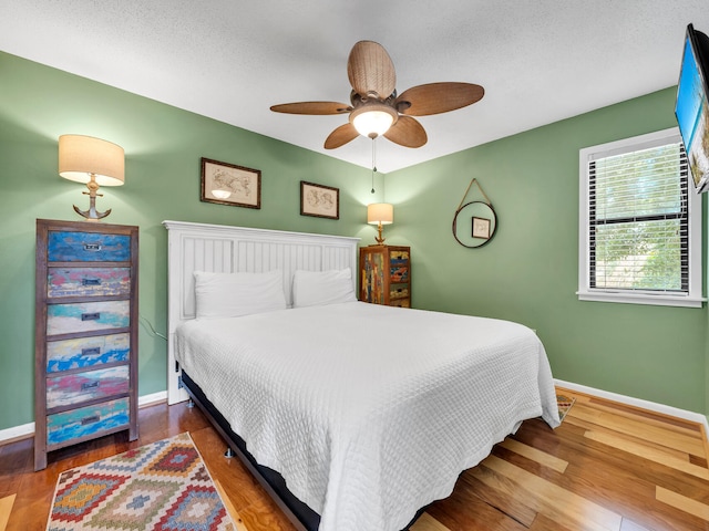 bedroom with hardwood / wood-style floors and ceiling fan