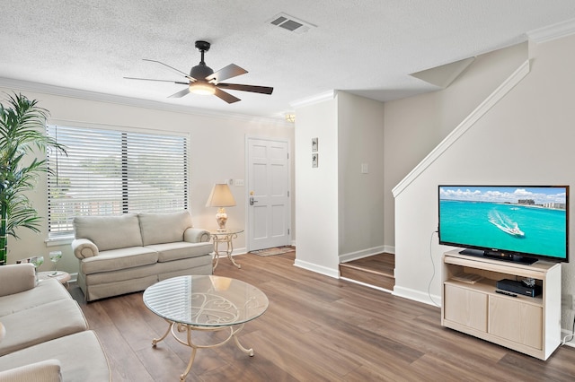 living room with ceiling fan, hardwood / wood-style floors, and crown molding