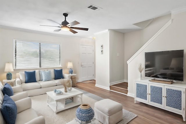 living room featuring hardwood / wood-style flooring, ceiling fan, and ornamental molding