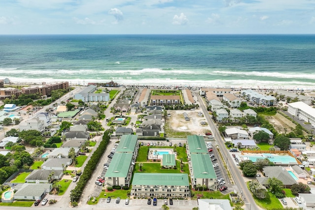 bird's eye view with a water view and a beach view