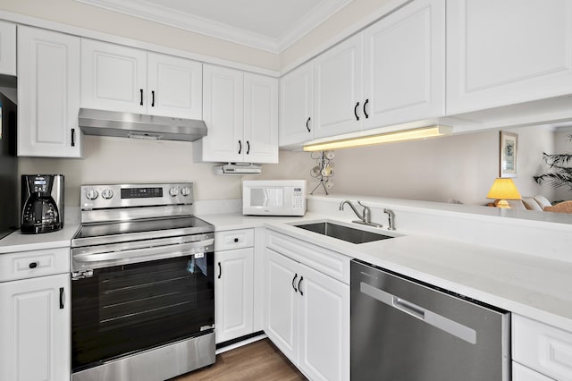 kitchen with crown molding, sink, white cabinets, and stainless steel appliances