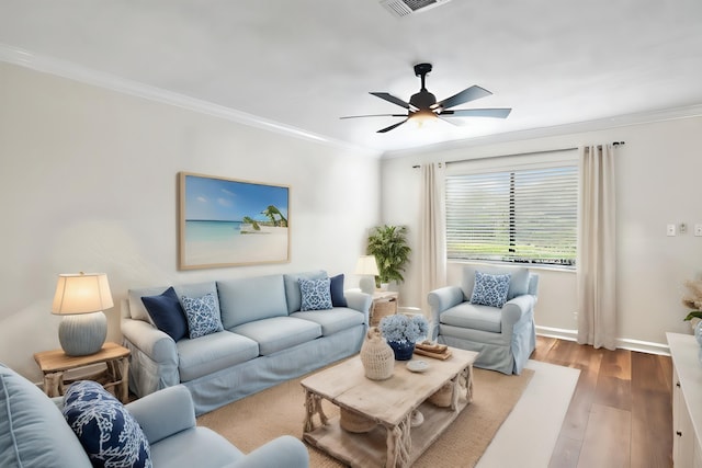 living room featuring hardwood / wood-style floors, ceiling fan, and ornamental molding