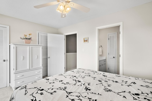 bedroom featuring carpet flooring, ceiling fan, and ensuite bathroom