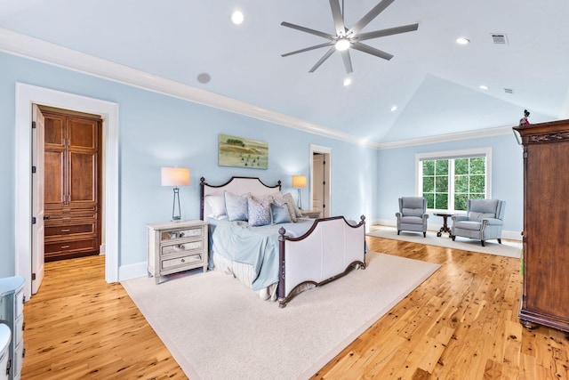 bedroom with ornamental molding, visible vents, vaulted ceiling, and light wood-style flooring