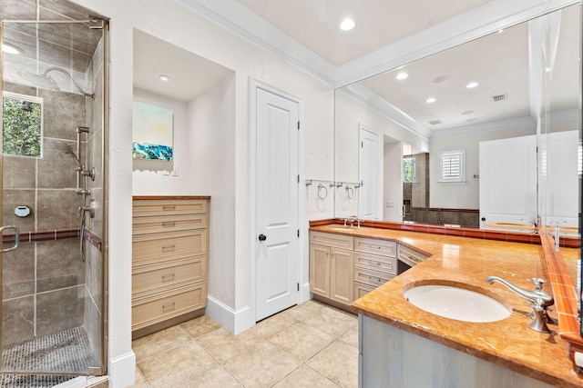 bathroom featuring vanity, ornamental molding, a shower stall, and visible vents