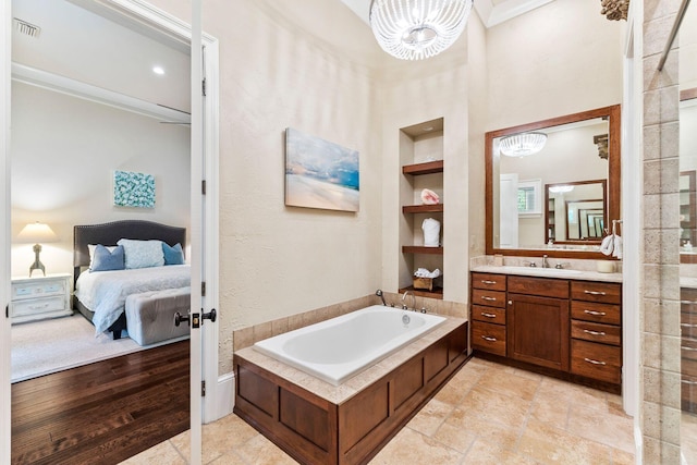 full bathroom with a garden tub, vanity, visible vents, built in features, and ensuite bath