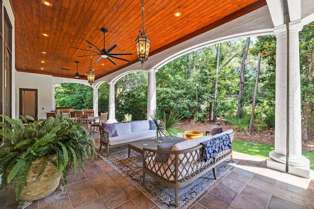 view of patio / terrace with an outdoor living space, a ceiling fan, and outdoor dining space