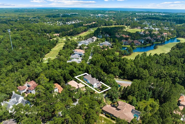 aerial view with a water view and a wooded view