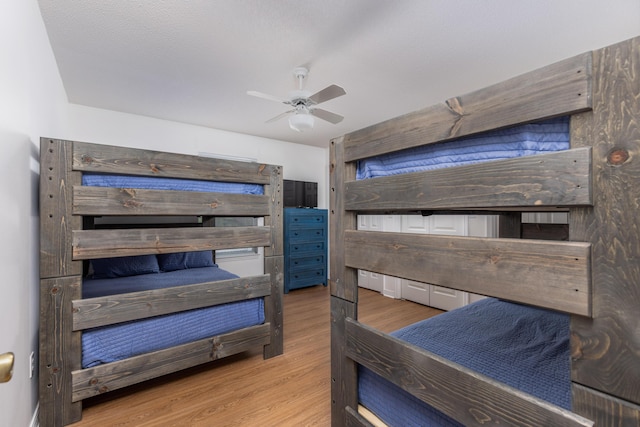 bedroom with hardwood / wood-style flooring and ceiling fan